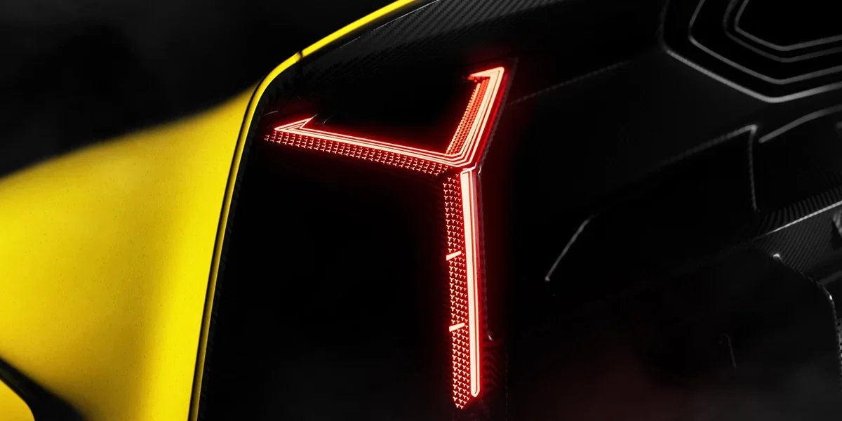 Close-up of Lamborghini Fenomeno sharp LED headlight with carbon fiber housing.
