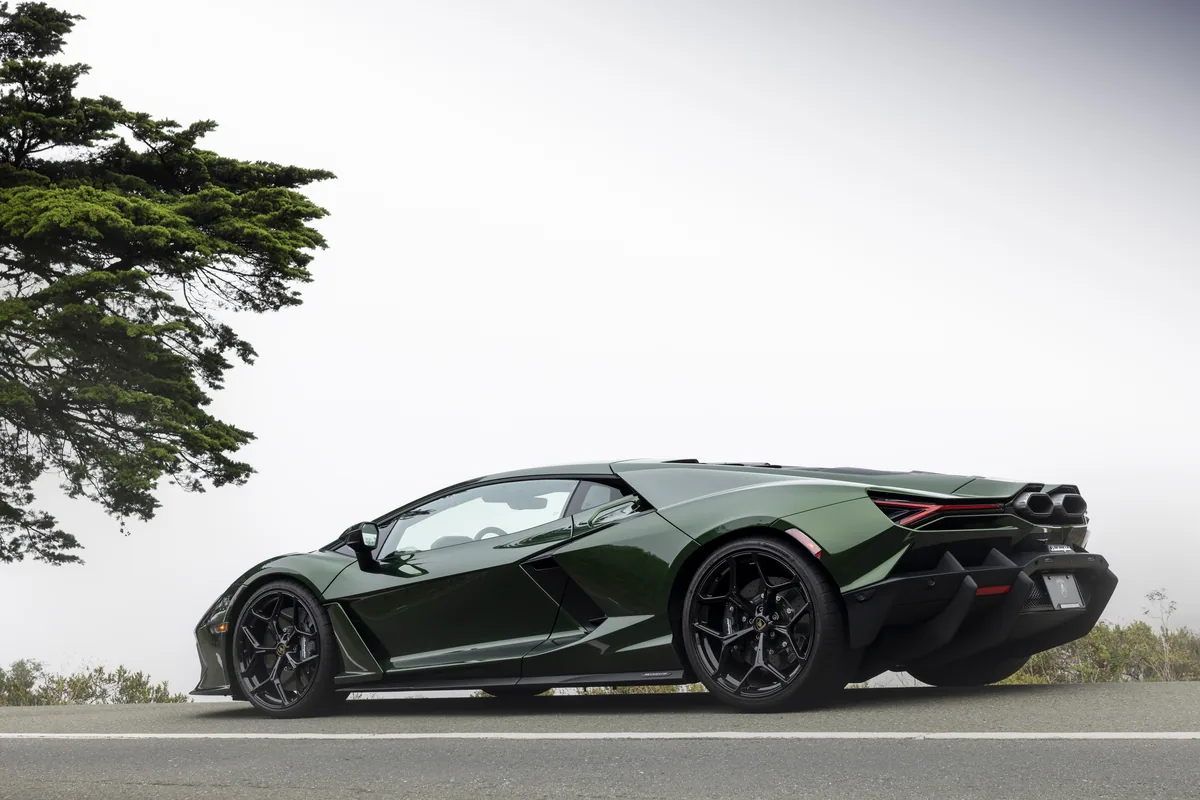 Green Lamborghini Revuelto beside a coastal cypress tree
