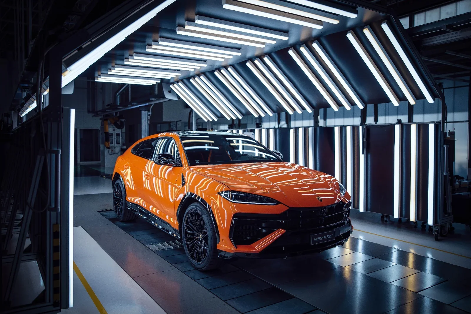 Orange Lamborghini Urus SE front view on the production line