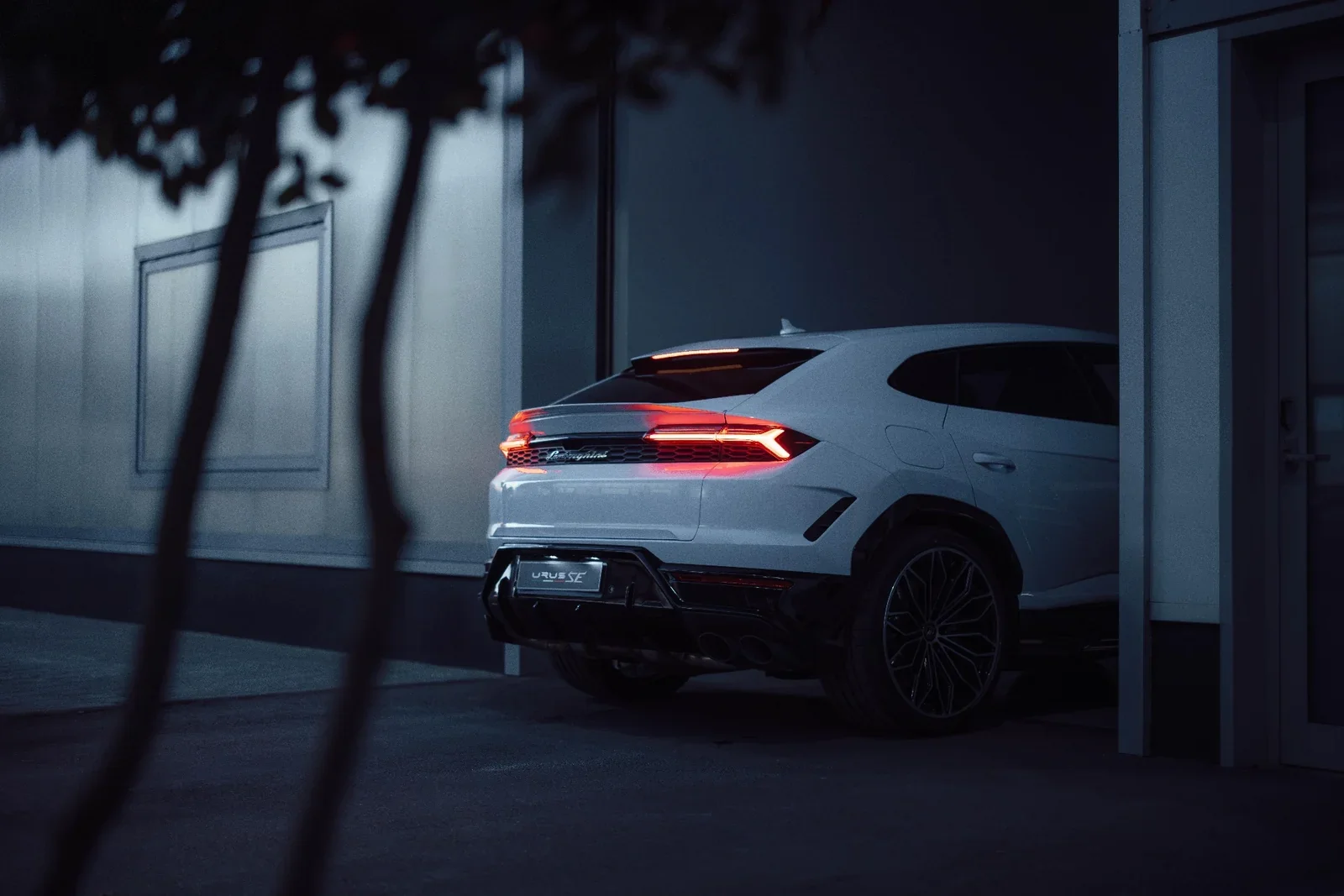 White Lamborghini Urus SE rear three-quarter factory view